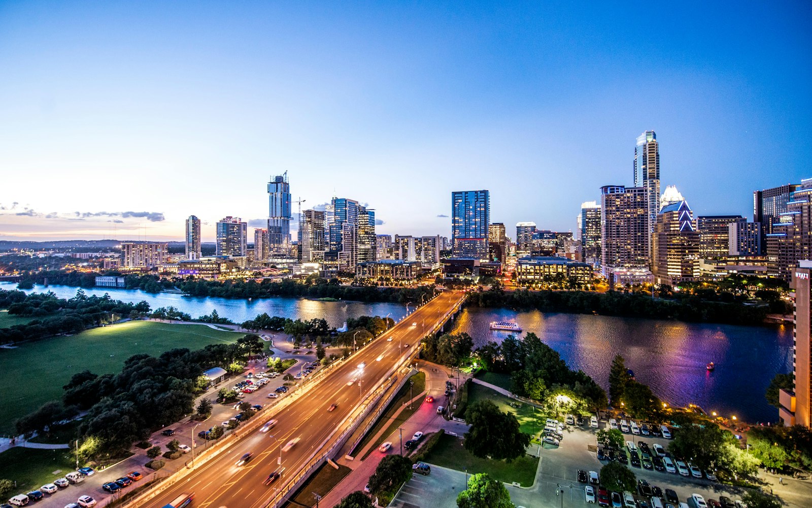 The downtown Austin skyline over Lady Bird Lake at dusk, a few minutes from The Foundry at Eastside